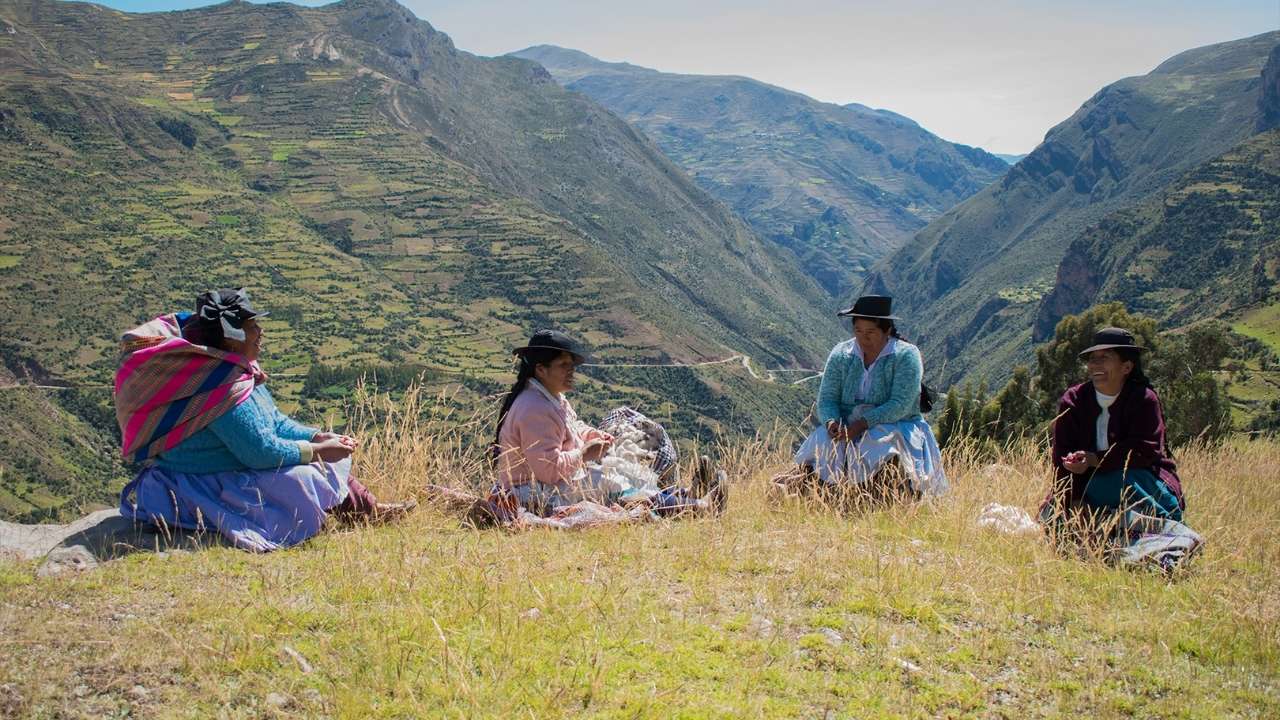 Four women sitting on a mountain